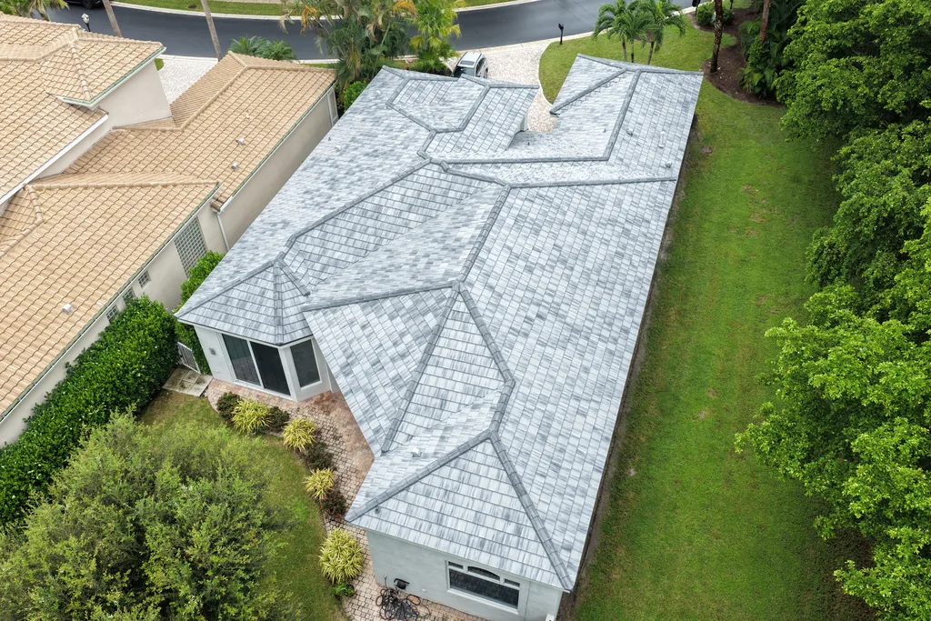 Aerial view of a home with a completed tile re-roof by All-Type Roofing Services